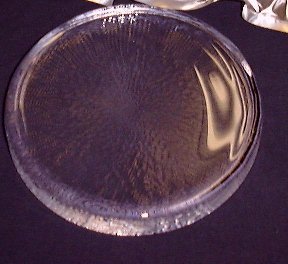 Boron oxide glass disk 184 mm black background foil wrapper at top